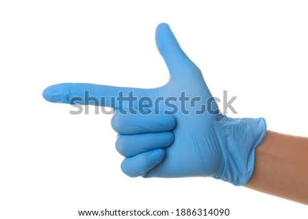 Person in blue latex gloves pointing at something against white background, closeup on hand