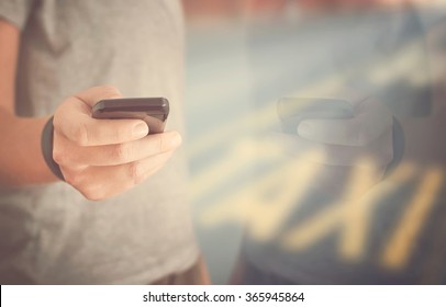 Person Booking Taxi On Smart Phone