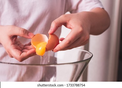 person breaking an egg into a bowl - Powered by Shutterstock