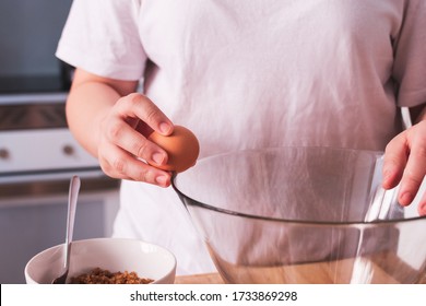 Person Breaking An Egg Into A Bowl