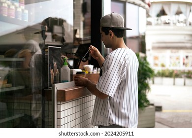 Person Buying Food And Coffee In City Street Cafe 