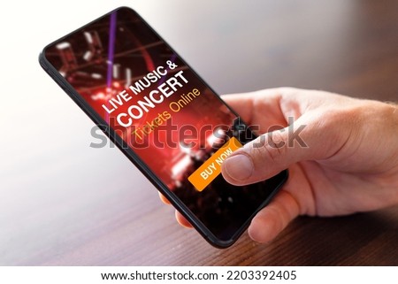 Person buying music concert tickets online on mobile phone