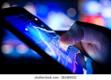 A person checking stock market data on a mobile device.