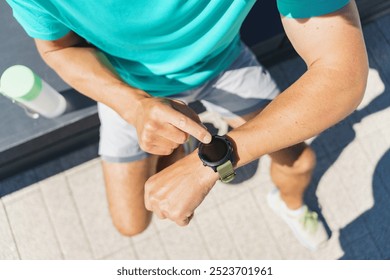 A Person Checking Their Smartwatch While Sitting on a Sunny Outdoor Bench in a Park During the Afternoon - Powered by Shutterstock