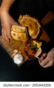 person choosing an empanada to enjoy a traditional meal in national holidays, Chile