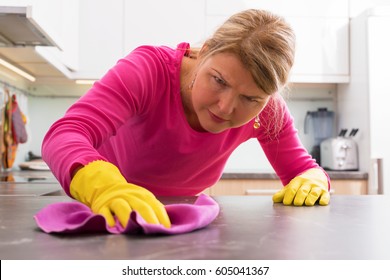 Person Cleaning The Hard Stains From Counter