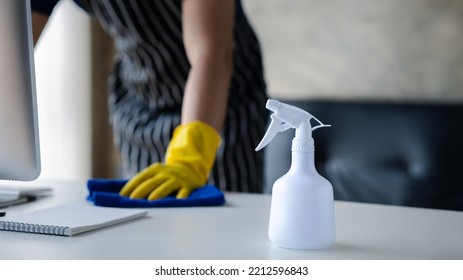 Person Cleaning The Room, The Cleaner Is Wiping The Desk In The Company Office. Cleaning Staff. Concept Of Cleanliness In The Organization.