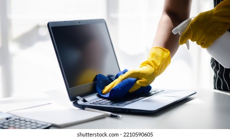 Person Cleaning Room, Cleaning Worker Is Using Cloth To Wipe Computer Screen In Company Office Room. Cleaning Staff. Concept Of Cleanliness In The Organization.