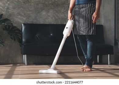 Person Cleaning Room, Cleaning Worker Is Using A Vacuum Cleaner To Clean The Living Room Floor In The Company Office. Cleaning Staff. Maintaining Cleanliness In The Organization.