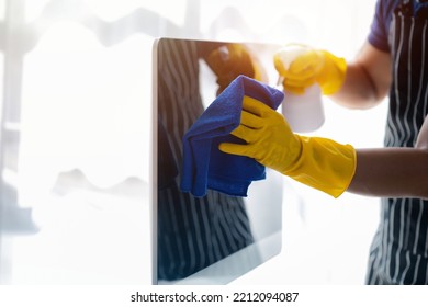 Person Cleaning Room, Cleaning Worker Is Using Cloth To Wipe Computer Screen In Company Office Room. Cleaning Staff. Concept Of Cleanliness In The Organization.