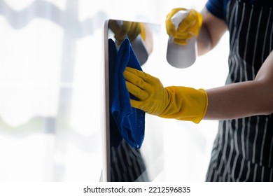 Person Cleaning Room, Cleaning Worker Is Using Cloth To Wipe Computer Screen In Company Office Room. Cleaning Staff. Concept Of Cleanliness In The Organization.