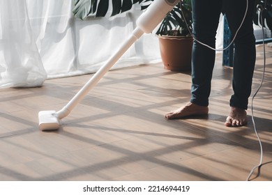 Person Cleaning Room, Cleaning Worker Is Using A Vacuum Cleaner To Clean The Living Room Floor In The Company Office. Cleaning Staff. Maintaining Cleanliness In The Organization.