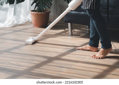 Person Cleaning Room, Cleaning Worker Is Using A Vacuum Cleaner To Clean The Living Room Floor In The Company Office. Cleaning Staff. Maintaining Cleanliness In The Organization.