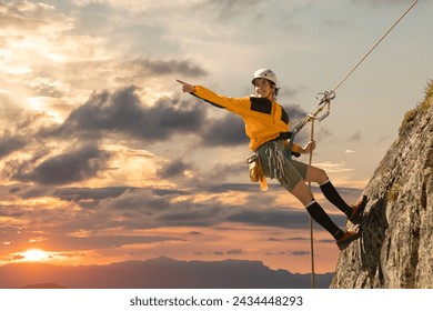 Person climbing in high mountains with yellow jacket rope and helmet in nature, confidence and risk, safety - Powered by Shutterstock