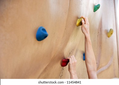 A Person Climbing A Rock Wall In The Park