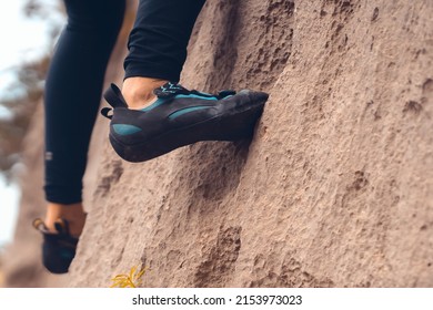 A Person Climbs The Mountain In Special Climbing Shoes, Close-up View Of The Legs With Copy Space. A Woman Is Engaged In Active Extreme Sports, Mountaineering And Climbing.