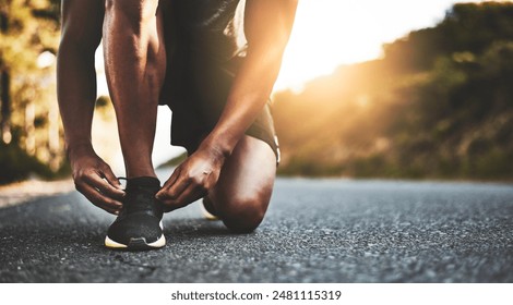 Person, closeup and tying shoes with hands in street for running, morning workout or outdoor exercise. Active athlete, runner or tie laces in preparation, getting ready or fitness for cardio on road - Powered by Shutterstock