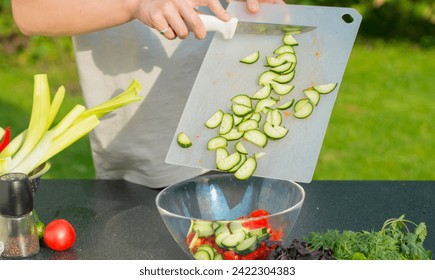 person cooking. male hands with dough, hands peeling, cutting potatoes, onions, cucumbers - Powered by Shutterstock