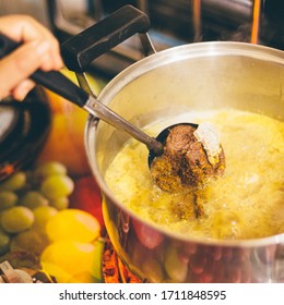 A Person Cooking Thai Yellow Curry With Fish Fillet And Fresh Ingredients