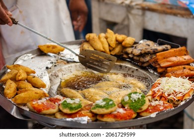 Person Cooking In A Typical Mexican Street Market With A Palette And Hot Oil