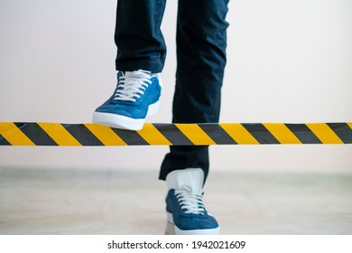 person cross the black and yellow stop line, braking the limit concept  - Shutterstock ID 1942021609