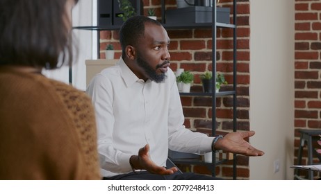 Person Dealing With Anger Management Issues Attending Aa Group Therapy Meeting With People In Circle. Man Making Confession About Mental Health Problems And Depression At Rehab Program.