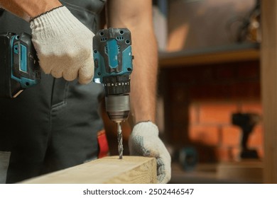 A person demonstrates woodworking techniques by using a power drill to create precise holes in a wooden plank - Powered by Shutterstock