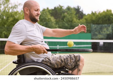 A person with a disability playing tennis on an outdoor court, exemplifying determination and enjoyment in adaptive sports. - Powered by Shutterstock