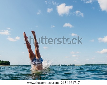 person diving into the water, view on human legs
