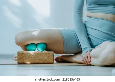 Person Doing Self Myofascial Release Of Adductors With Two Massage Balls On Cork Block.