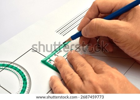 A person is drawing basic geometric shapes with precision tools. A concept for education, engineering, design, and meticulous planning.
Hands of a designer, architect, or student at work.