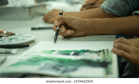 Person Drawing By Hand With Pen, Pencil And Ink, Architectural Perspectives, In Color. Drawing On Paper On A Drawing Board Or Desk.