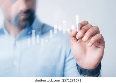 A person draws digital graphs on a transparent screen. Business and technology concept with graphs and charts. Innovation in digital graphs and data analysis. Business graph, data analysis