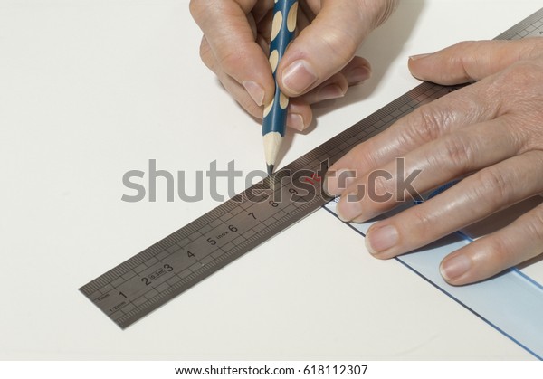 A person draws a line\
with a pencil