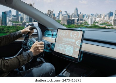 Person driving an electric car with a futuristic, high-tech dashboard and city skyline in the background.