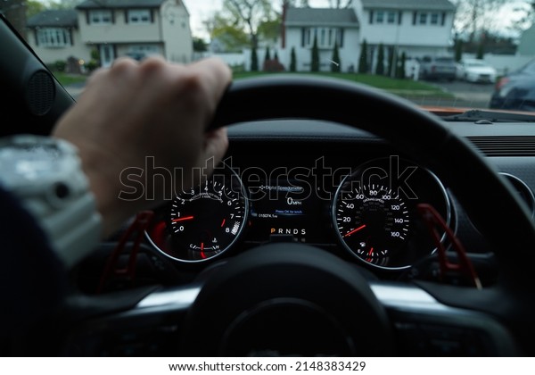 Person driving sports car\
dashboard