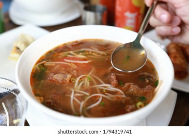 Person Eating Bun Ca Vermicelli Fish Soup In Vietnamese Restaurant