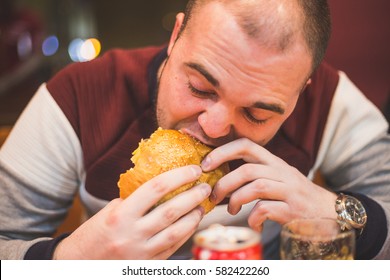 Person Eating Burger; Concept Of Unhealthy Lifestyle 