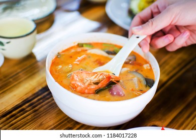 Person Eating Thai Tom Yum Gong Soup In A Restaurant