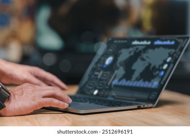 A person engages with a laptop displaying detailed analytics and world map data visualizations, emphasizing the importance of technology in understanding global trends and decision-making