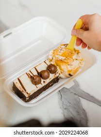 Person Enjoys A Brownie Sundae