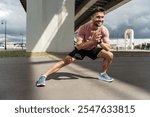 Person Exercising Outdoors Under a Bridge During Cloudy Weather, Engaging in a Lateral Stretch Routine