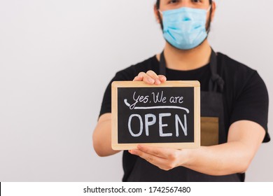 Person With Facial Mask Holds A Sign Saying 