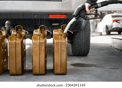 Person filling gas canister at gas station - Powered by Shutterstock