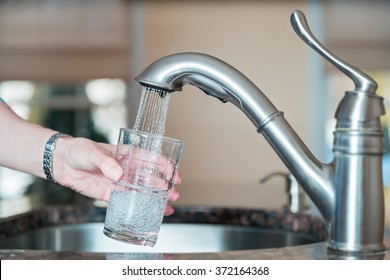 Person Filling Up A Glass Of Tap Water