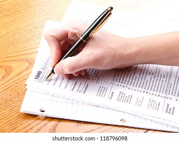 Person Filling Out A 1040 Tax Form