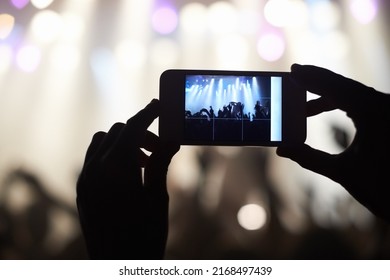 A Person Filming Their Favourite Band With A Camera Phone. This Concert Was Created For The Sole Purpose Of This Photo Shoot, Featuring 300 Models And 3 Live Bands. All People In This Shoot Are Model