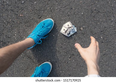 Person Find Paper Money Lost And Dropped On The Asphalt Ground Outdoor