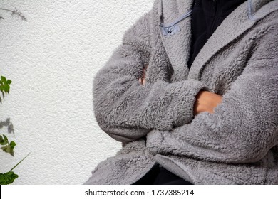 Person With Folded Arms And A Gray Hairy Dressing Gown