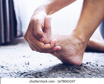 Person With Foot Pain And Nerve Inflammation And Foot Bone, Heel, And Joint Pain Use Hand Massage To Treatment Of Numb Toes.